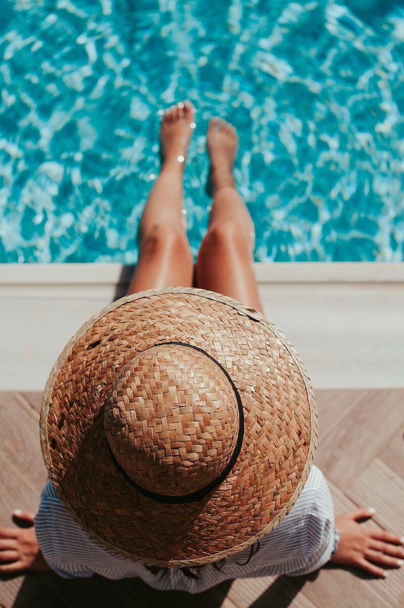 woman resting feet in swimming pool-1